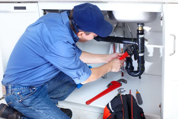 a male plumber fixing a toilet from Plumbing Lake Travis in Austin, TX  Plumber near me